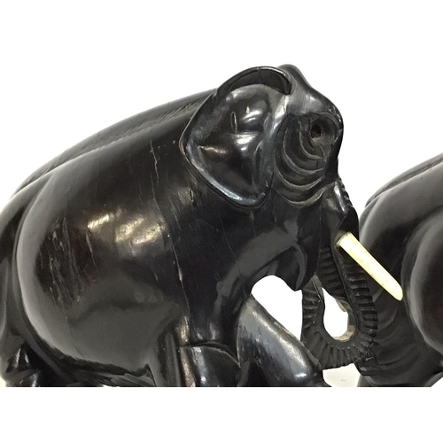 802 - A pair of ebony elephants 18cm tall approximately. Postage cat b