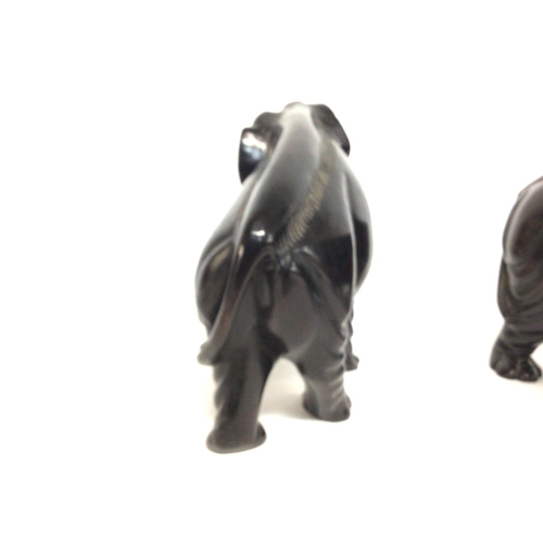 802 - A pair of ebony elephants 18cm tall approximately. Postage cat b