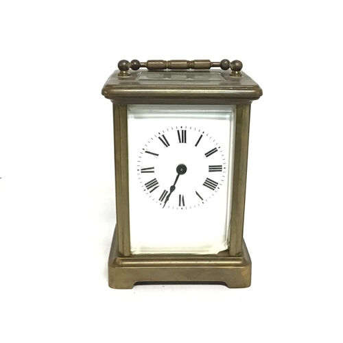 806 - A bronze bracket clock, made in France. Some slight damage. Approximately 11cm tall. Postage cat D