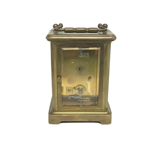 806 - A bronze bracket clock, made in France. Some slight damage. Approximately 11cm tall. Postage cat D