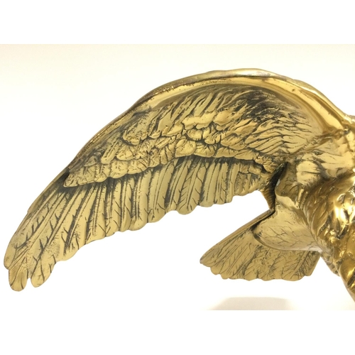 808 - A large brass Bald eagle perched on a log. Approximately 62cm tall, 70cm wide. Postage cat D