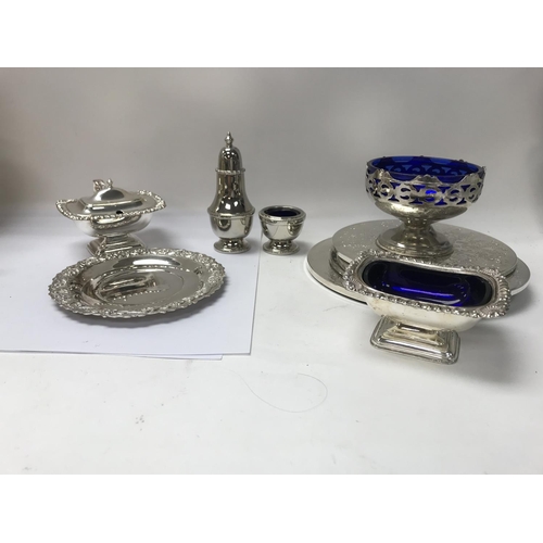 832 - A collection of silver plated condiments and place mats along with an epergne candelabra. Shipping c... 