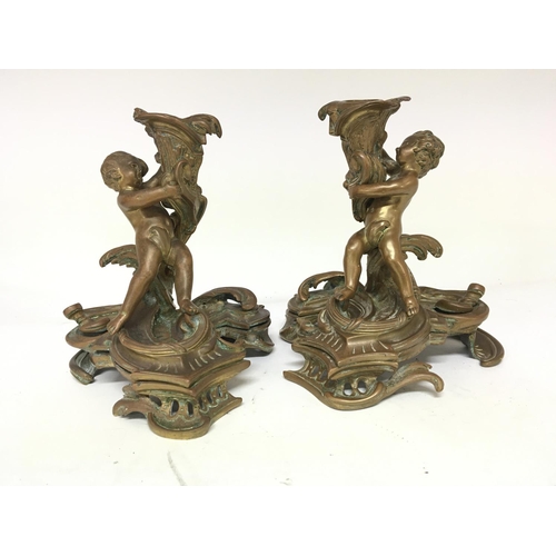 833 - A pair of French bronze and partially gilded candle sticks 19th century or earlier of rococo design ... 