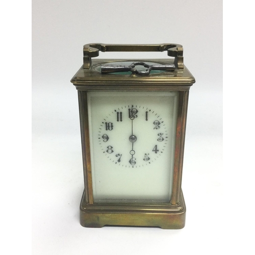 837 - A brass cased carriage clock with key. Shipping category D.