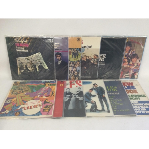 400 - A collection in two bags of 20 Beatles compilation LPs including the red and blue albums on coloured... 