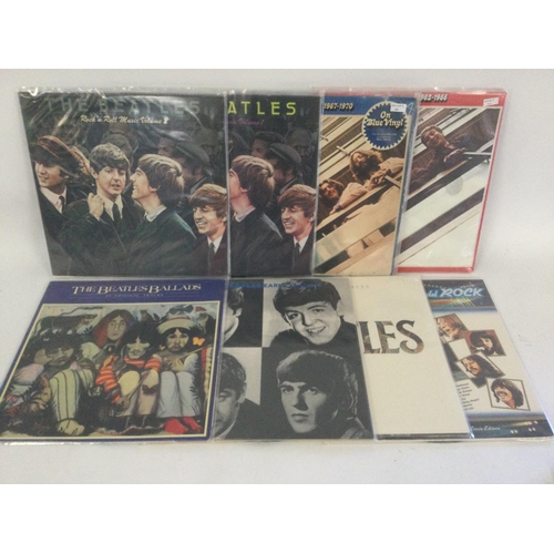 400 - A collection in two bags of 20 Beatles compilation LPs including the red and blue albums on coloured... 