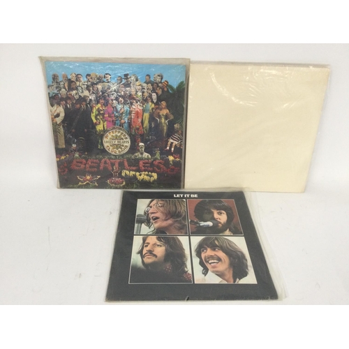 471 - A 180g pressing of The Beatles 'White Album', 'Let It Be' and 'Sgt Pepper'.