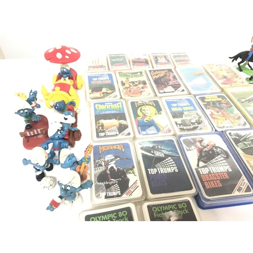 129 - A Box Containing Vintage Top Trumps. Smurfs and Britains.No Reserve.