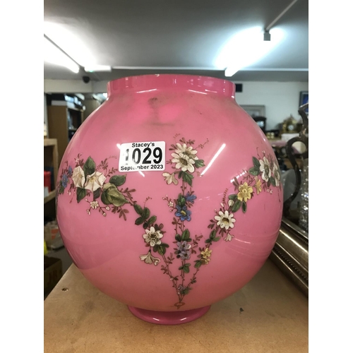 1029 - A Victorian pink glass shade decorated with raised painted flowers and foilage. 27cm in height