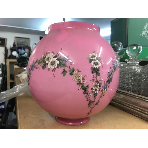 1029 - A Victorian pink glass shade decorated with raised painted flowers and foilage. 27cm in height