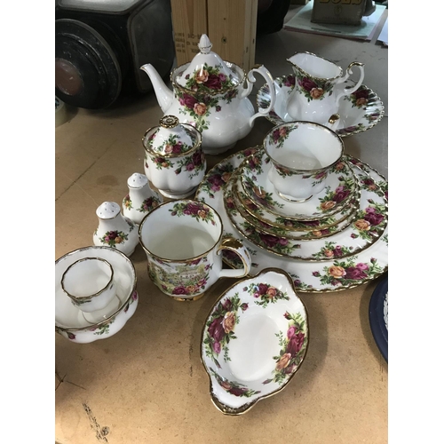 1034 - A small collection of Royal Albert Country Rose tea ware including tea pot milk jug and sugar bowl .