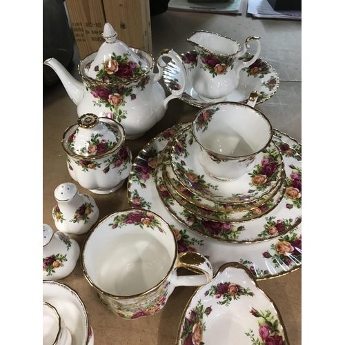 1034 - A small collection of Royal Albert Country Rose tea ware including tea pot milk jug and sugar bowl .