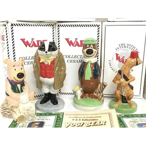 1042 - A collection of boxed Wade ceramic figures including Yogi Bear, Huckleberry Hound, Boo Boo, Pixie & ... 