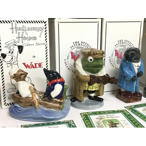 1042 - A collection of boxed Wade ceramic figures including Yogi Bear, Huckleberry Hound, Boo Boo, Pixie & ... 