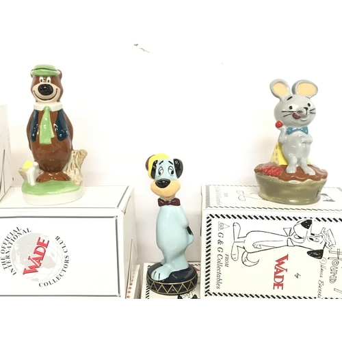 1042 - A collection of boxed Wade ceramic figures including Yogi Bear, Huckleberry Hound, Boo Boo, Pixie & ... 