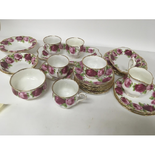 1053 - A Royal Albert Old English Rose part tea and dinner service four cups saucers bowls and plates.