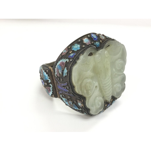 1102 - A large silver and jade bangle carved in the form of a butterfly with cloisonne decoration. Shipping... 