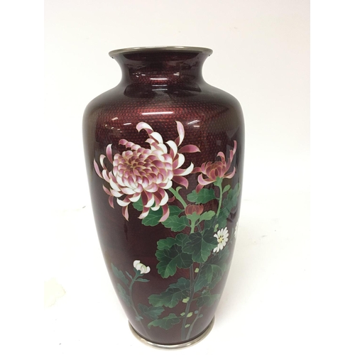 1106 - A Quality Japanese Cloisonné vase decorated with flowers and foliage on a red ground no obvious dama... 