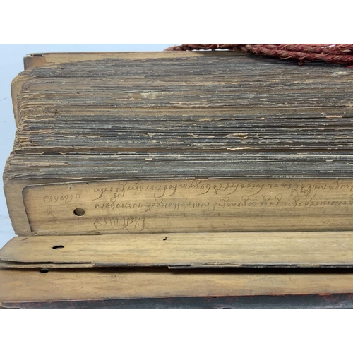 1113 - An Early 20thC palm leaf scripture with wooden covers, written in Tamil, Possibly Sri Lankan origin.... 