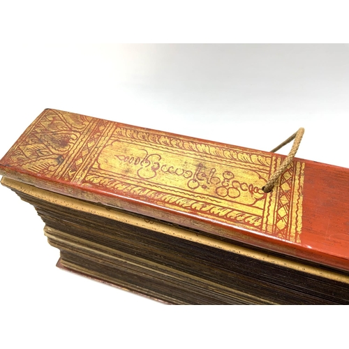 1114 - An Early 20thC palm leaf scripture with lacquered wooden covers, written in Tamil, Possibly Sri Lank... 