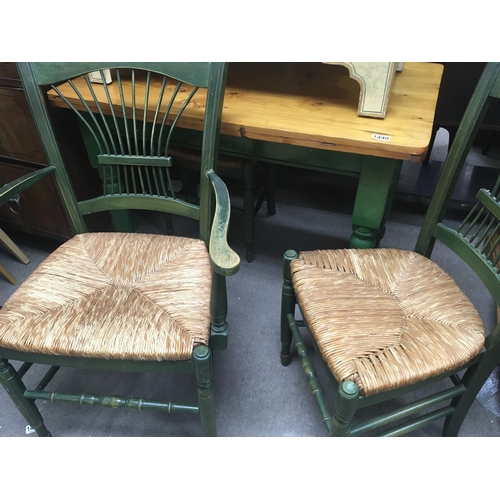 1271 - A green painted pine kitchen table with three green chairs with rush seats.