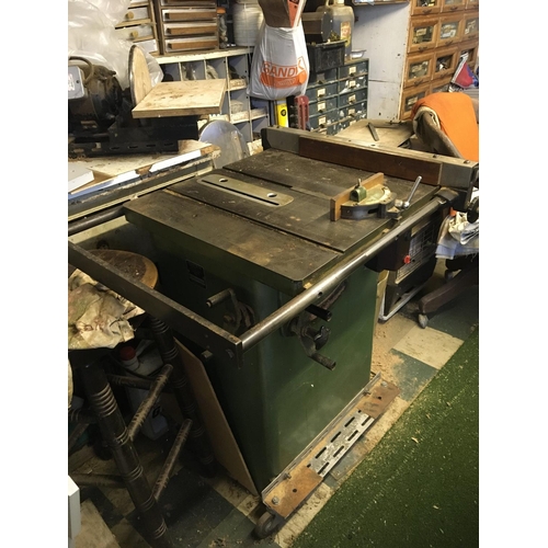 1298 - Two electric table saws with numerous cutting blades steel top beds and finished in green (2)