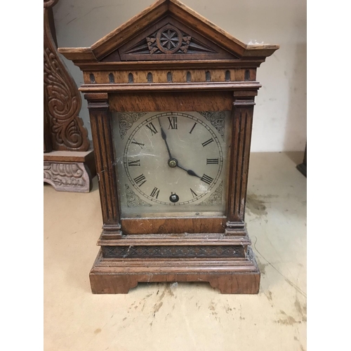 1331 - A walnut mantle clock with applied carvings the circular dial with Roman numerals. Together with two... 