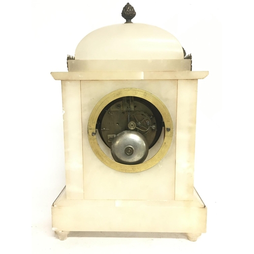 1350 - A French Onyx clock decorated with pillars, acorns and a bronzed dial. 34cm tall with key. Postage c... 