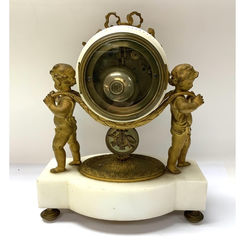 1363 - A mid 19th Century gilt bronze mantle clock. The clock having two cherubs carrying the clock face Th... 