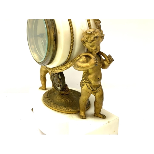 1363 - A mid 19th Century gilt bronze mantle clock. The clock having two cherubs carrying the clock face Th... 