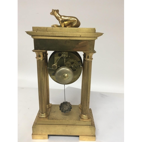 1365 - A Quality French four pillar brass clock second Empire the top,surmounted with a dog silk suspension... 