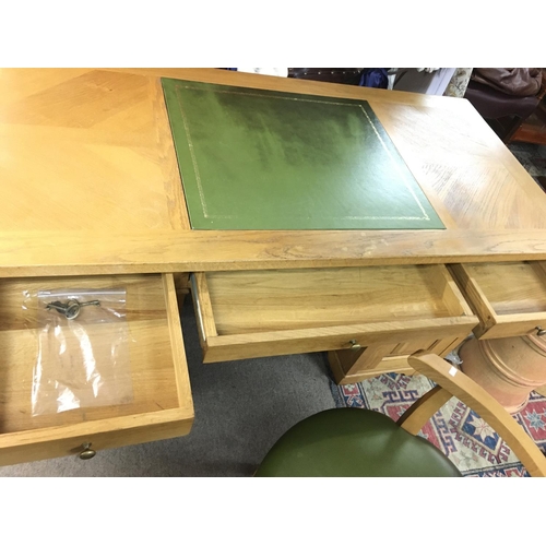 1366 - An oak pedestal desk with green leather centre and matching chair. Desk is approx 150cm wide by 70 d... 