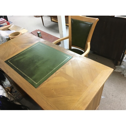 1366 - An oak pedestal desk with green leather centre and matching chair. Desk is approx 150cm wide by 70 d... 