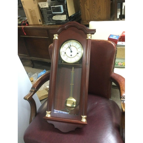 1392 - A reproduction wall clock and a brass clock under a dome (2). Shipping category D.