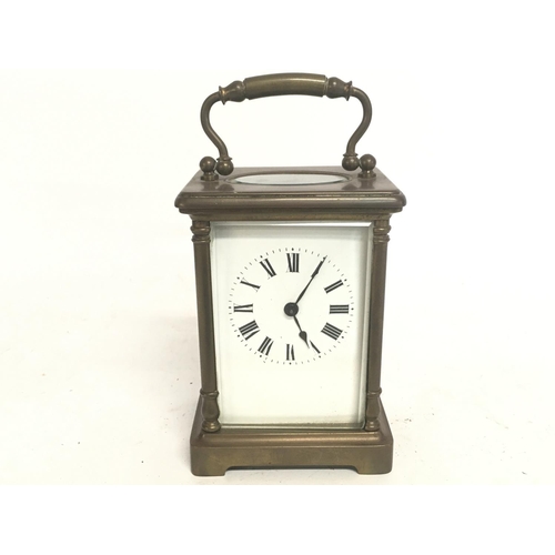 1540 - A cased French 8 Day Brass Carriage clock, with turned side pillars and bevel glass encasing. Circa ... 