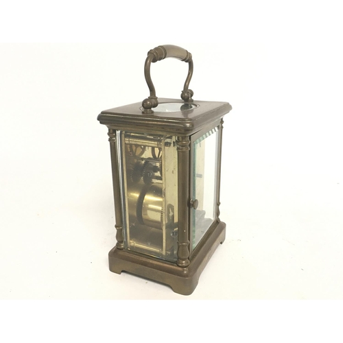 1540 - A cased French 8 Day Brass Carriage clock, with turned side pillars and bevel glass encasing. Circa ... 