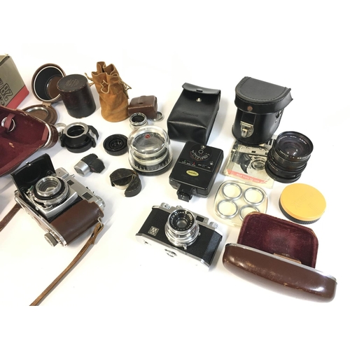 2006 - A collection of various cameras Hauna 35x contaflex Zeiss ikon four lenses and additional equipment.... 