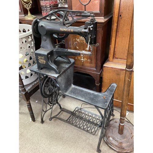 2020 - A Treadle operated Shoemakers 'Singer sewing machine' made from cast iron painted black with gold de... 