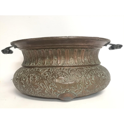 2054 - A Large vintage copper pressed planter decorated with various animals and floral patterns. 52cm wide... 