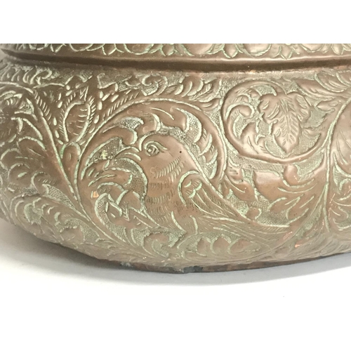 2054 - A Large vintage copper pressed planter decorated with various animals and floral patterns. 52cm wide... 