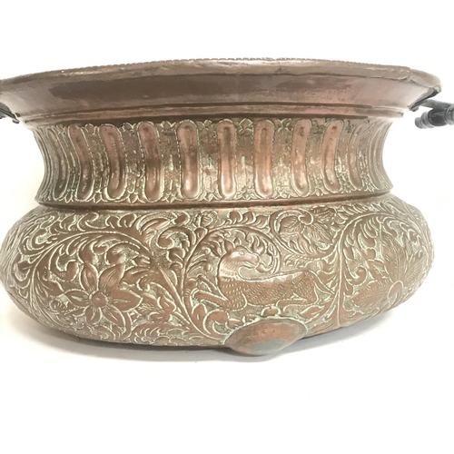 2054 - A Large vintage copper pressed planter decorated with various animals and floral patterns. 52cm wide... 