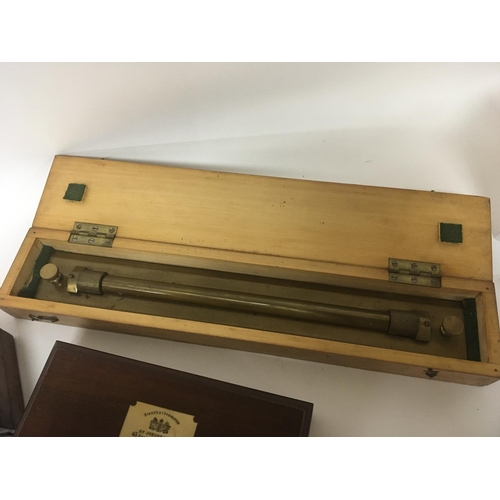 2098 - Three mahogany cased precision drawing sets. A large brass rolling ruler and two Sikes Hydrometer se... 