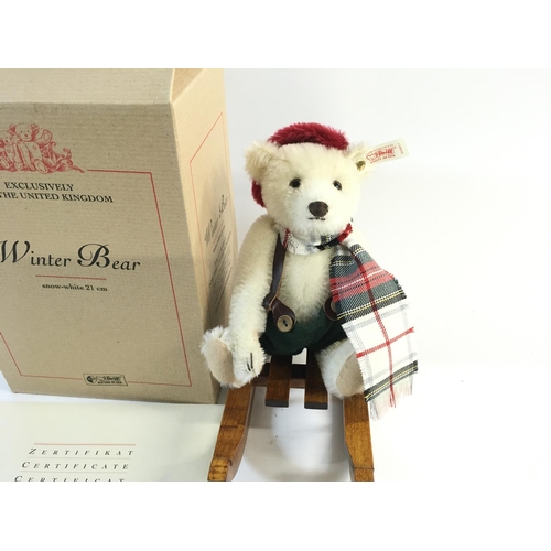 2115 - A limited edition Steiff bear with wooden sledge in box with certificate. Postage B