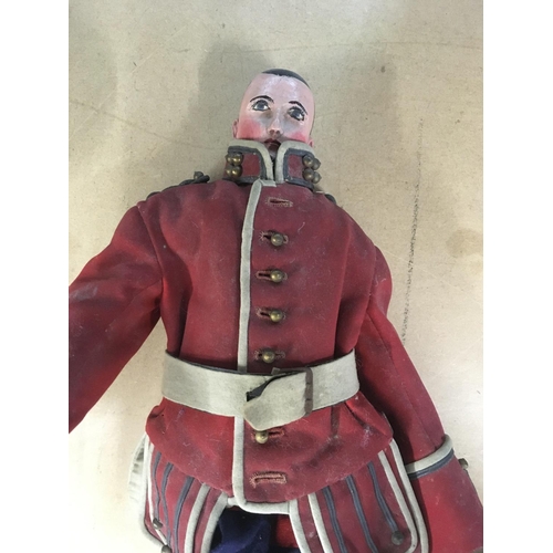 2121 - A 19 th century wooden joined doll in the form of a solider 53 cm .