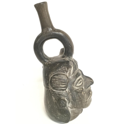 601 - Peruvian Pottery jug in the form of a head , approximately 24CM tall. Postage category B