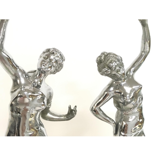 613 - Chrome Art Deco figures on marble bases, approximately 34cm tall. Postage category C