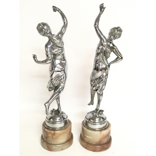 613 - Chrome Art Deco figures on marble bases, approximately 34cm tall. Postage category C