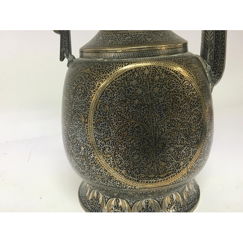 620 - A Quality white metal and silvered brass Middle Eastern Coffee pot with perfuse decoration height 44... 