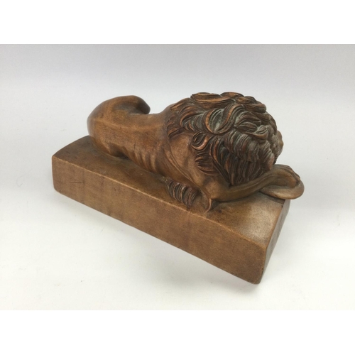 626 - A carved wooden lion, approx length 18cm. Shipping category B.