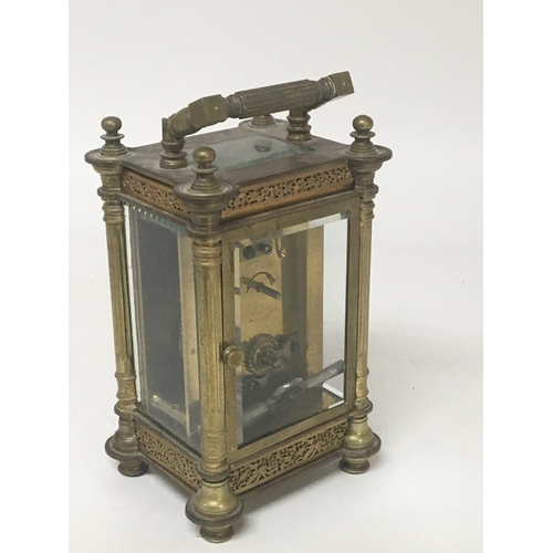 630 - An ornate brass Mappin and Webb carriage clock early 20th century with four content pillars elaborat... 